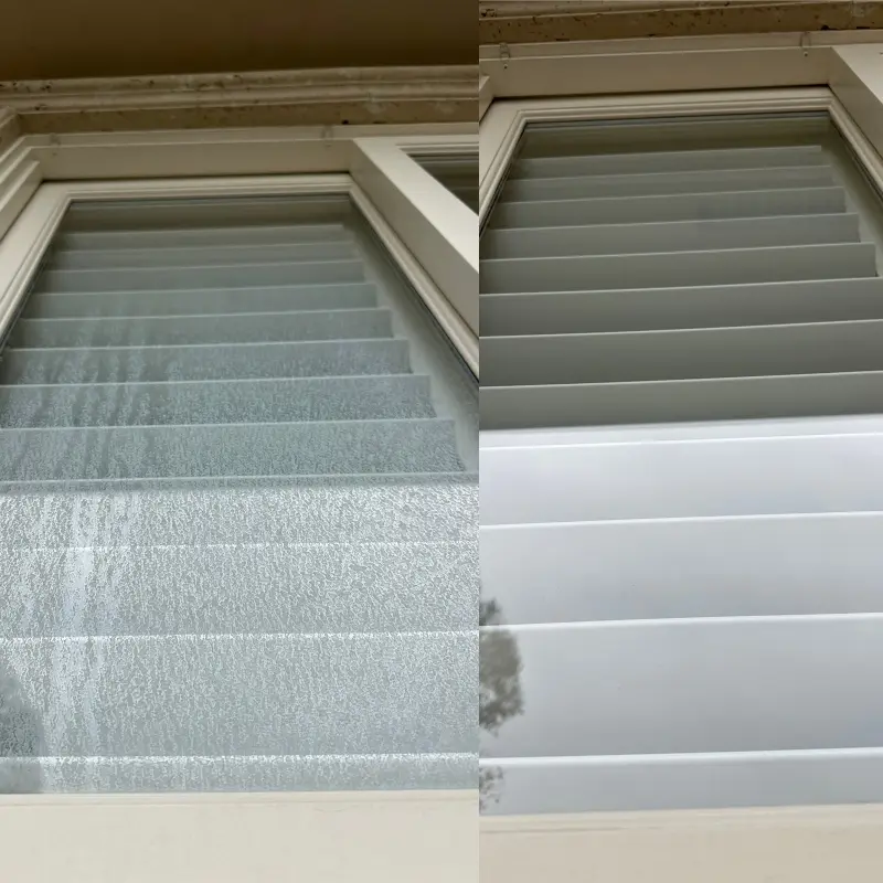 Side-by-side comparison of a residential window before and after cleaning: heavy hard-water mineral spotting on the left, clear glass and clean frame on the right